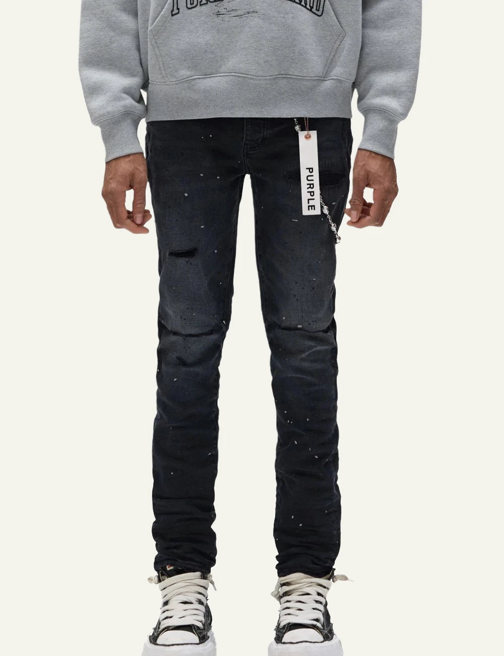 Purple Brand black skinny jeans with distressed knees and paint splatter front model view