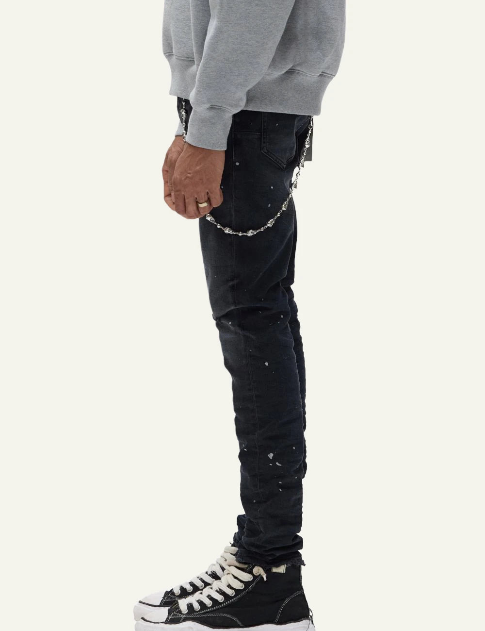 Purple Brand black skinny jeans with distressed knees and paint splatter side view