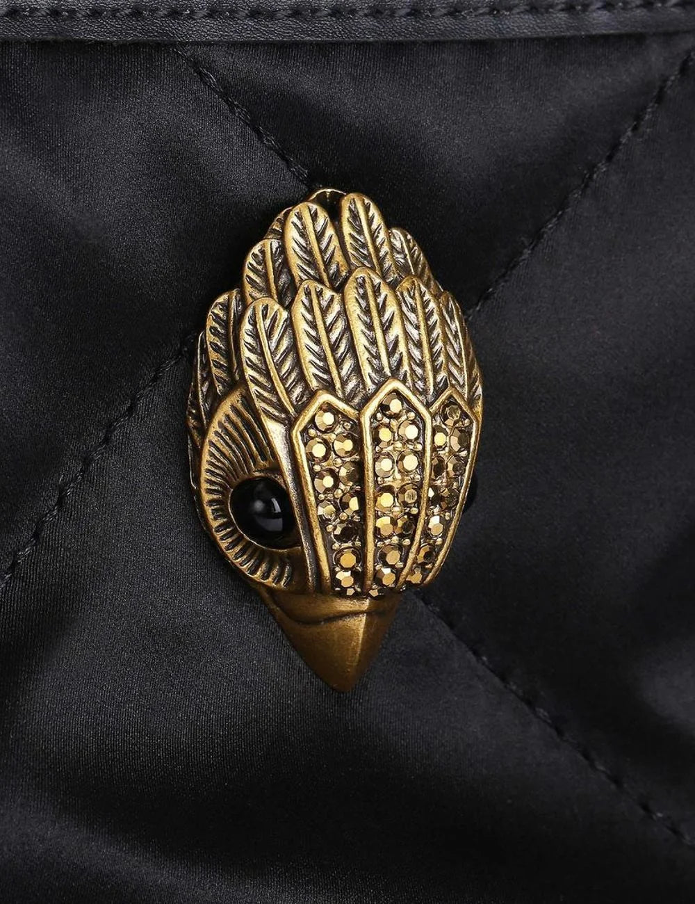 Detail eagle head logo Kurt Geiger London antique brass crystals