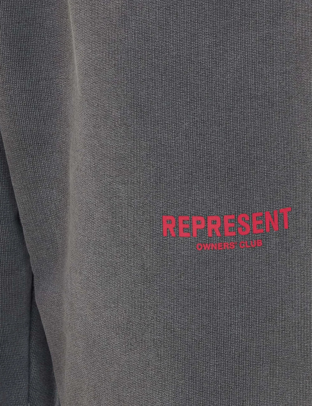 Represent washed dark grey sweatpants logo detail close up logo view