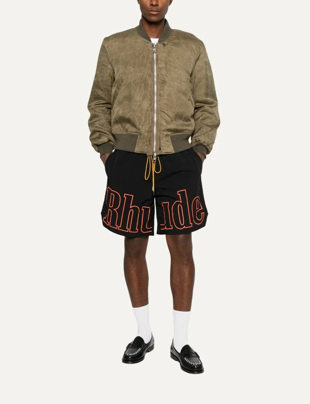 Rhude men's black nylon shorts with oversized orange outline logo print, elasticated waistband and contrasting yellow drawstring full body