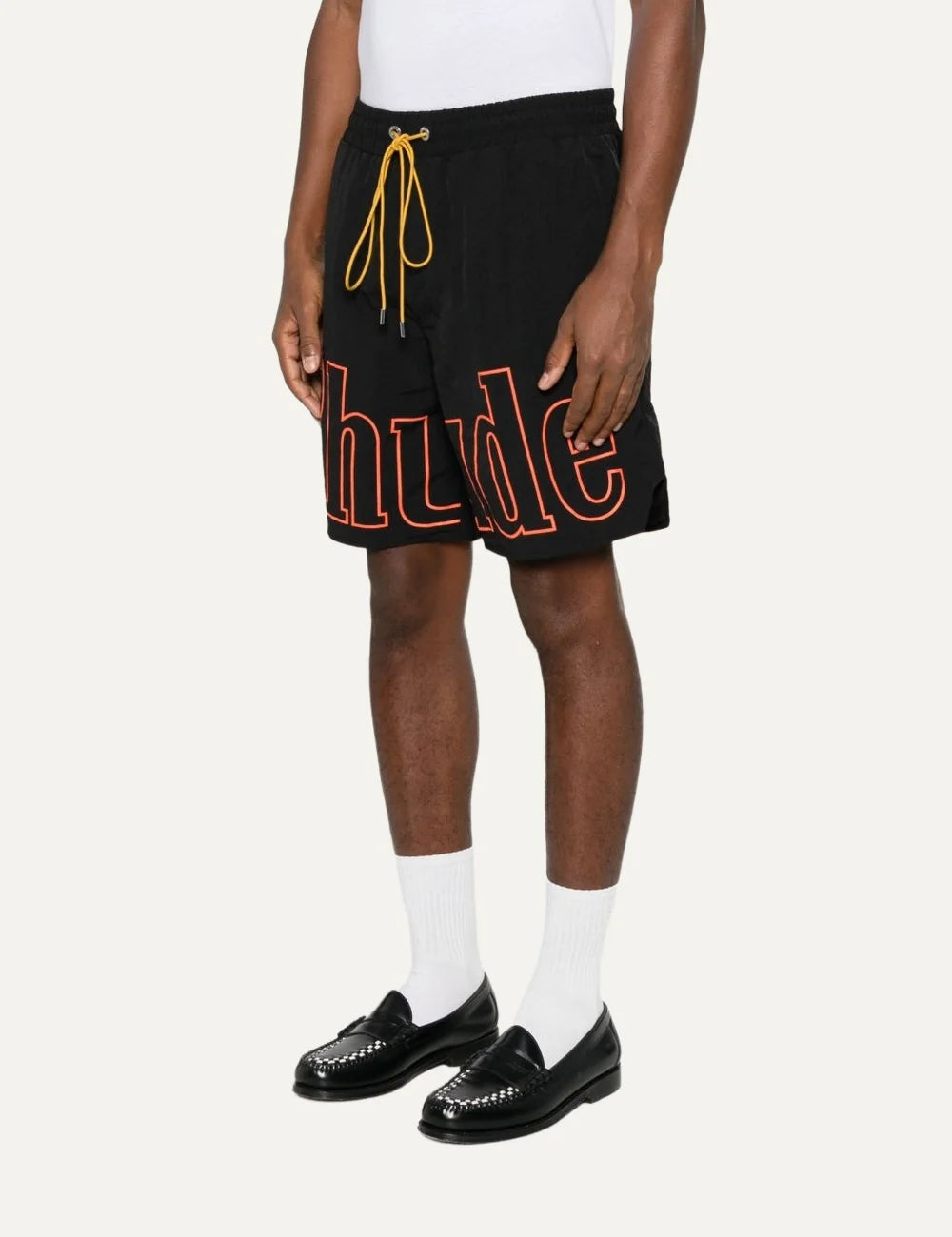 Rhude men's black nylon shorts with oversized orange outline logo print, elasticated waistband and contrasting yellow drawstring side