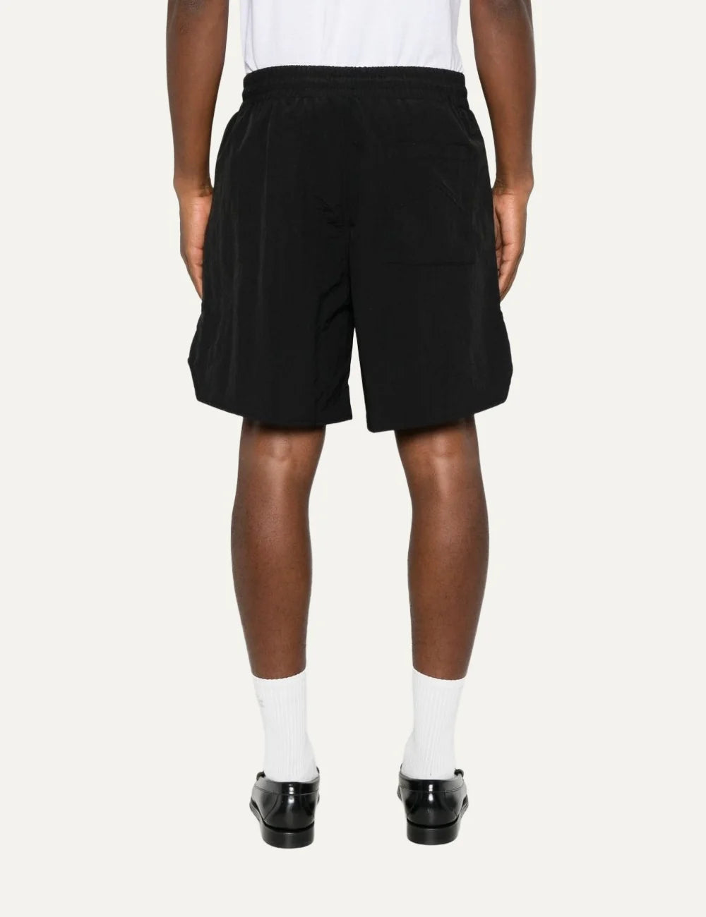 Rhude men's black nylon shorts with oversized orange outline logo print, elasticated waistband and contrasting yellow drawstring back