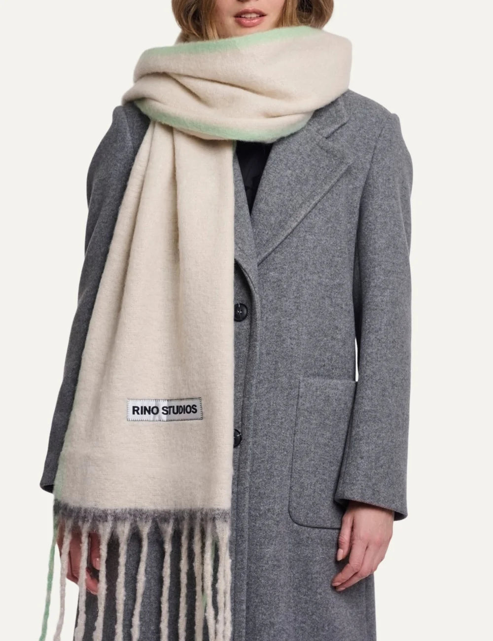 Rino Pelle women's oversized cream scarf with soft lime green accents, long fringes and Rino Studios logo patch.