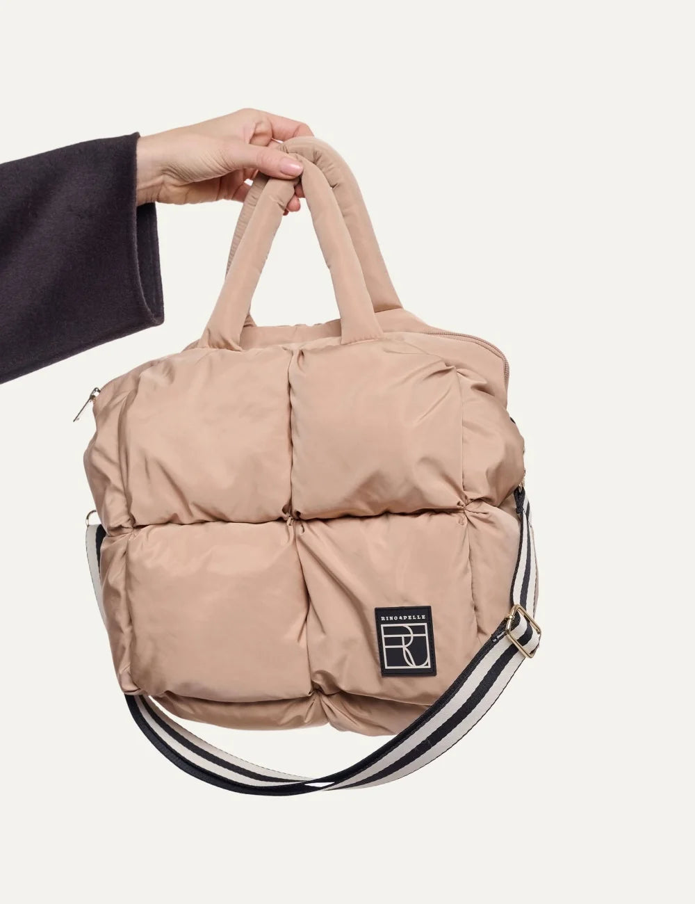 Rino Pelle women's light beige padded quilted handbag with puffy design, double handles, detachable shoulder strap and front logo patch.