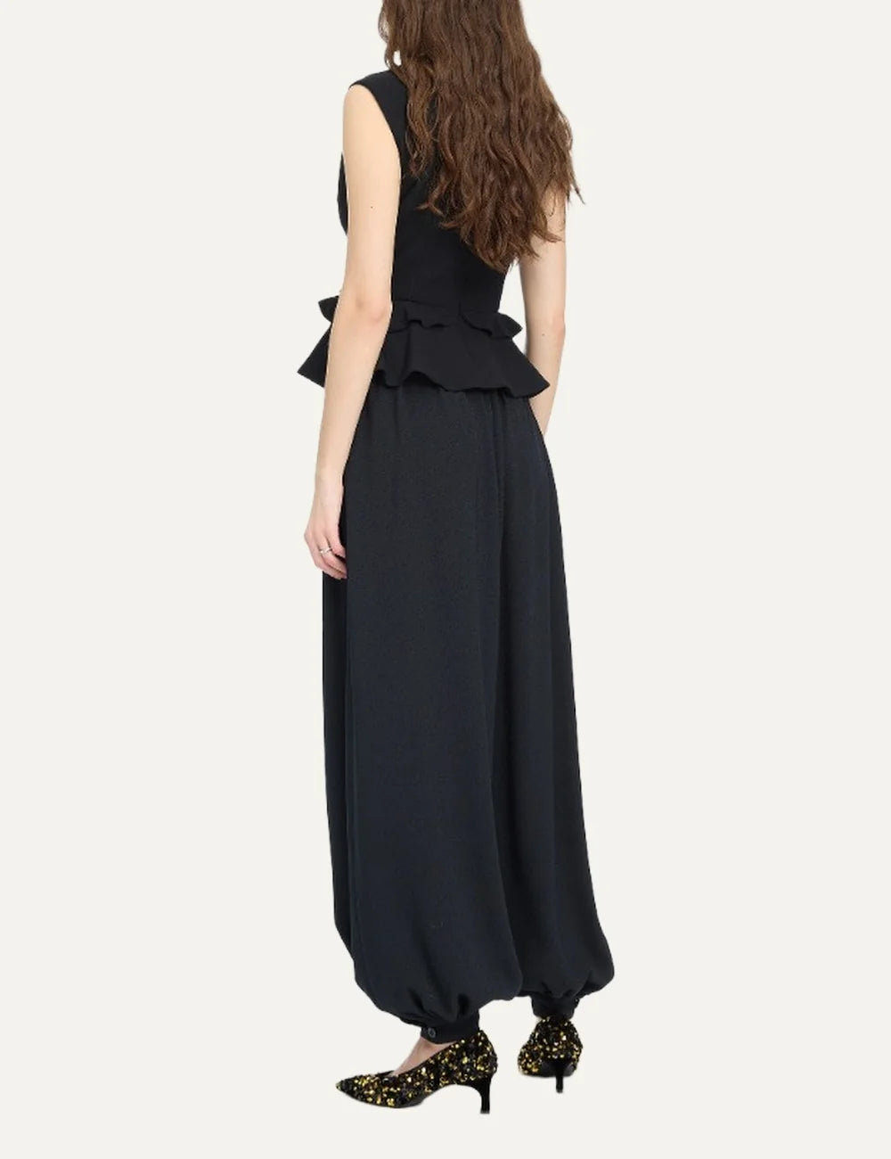 Rotate women black sleeveless V-neck top with structured shoulders, peplum hem and flower detail back