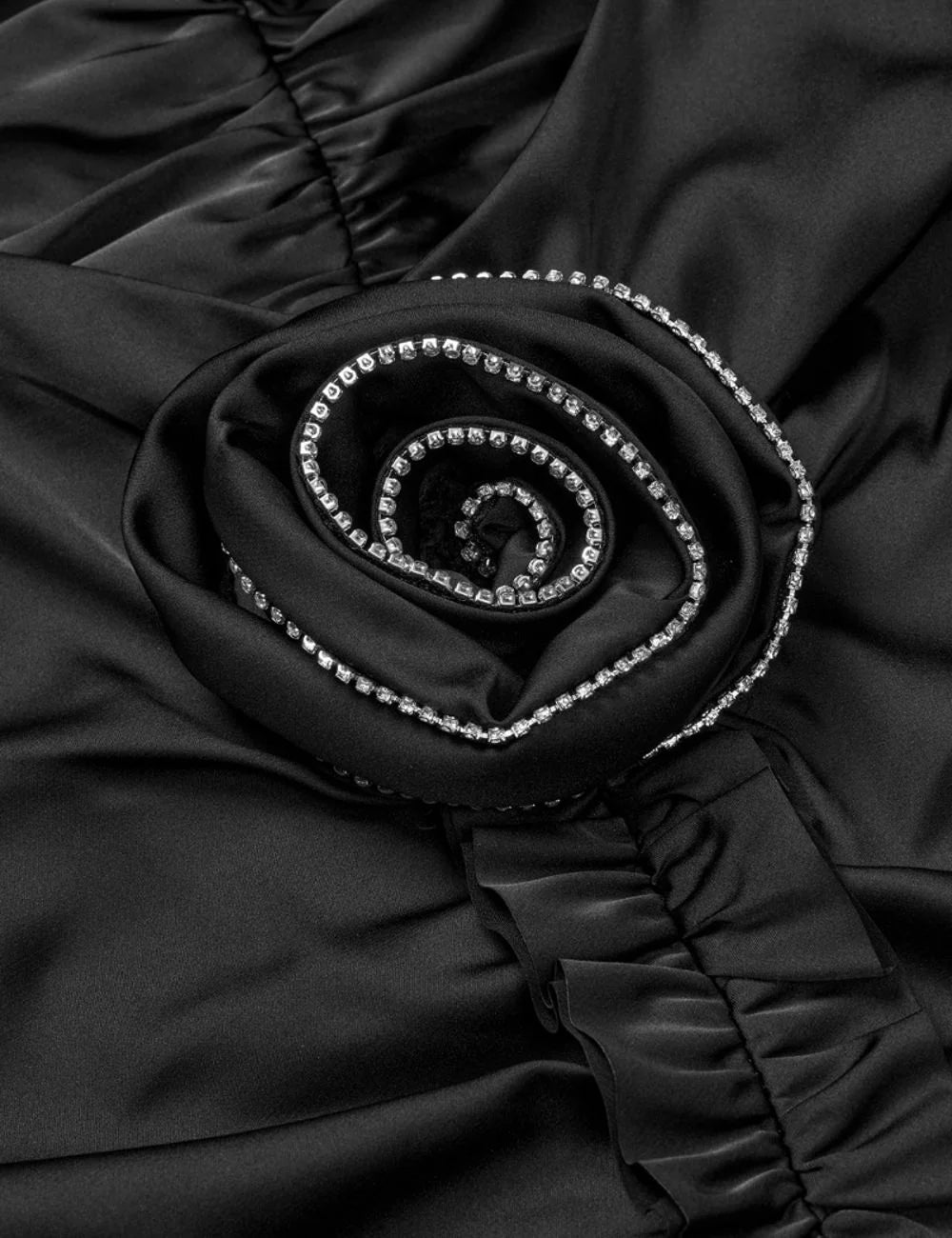 Rotate women black satin mini slip dress with ruched detailing, thin straps and rhinestone embellished rose detail