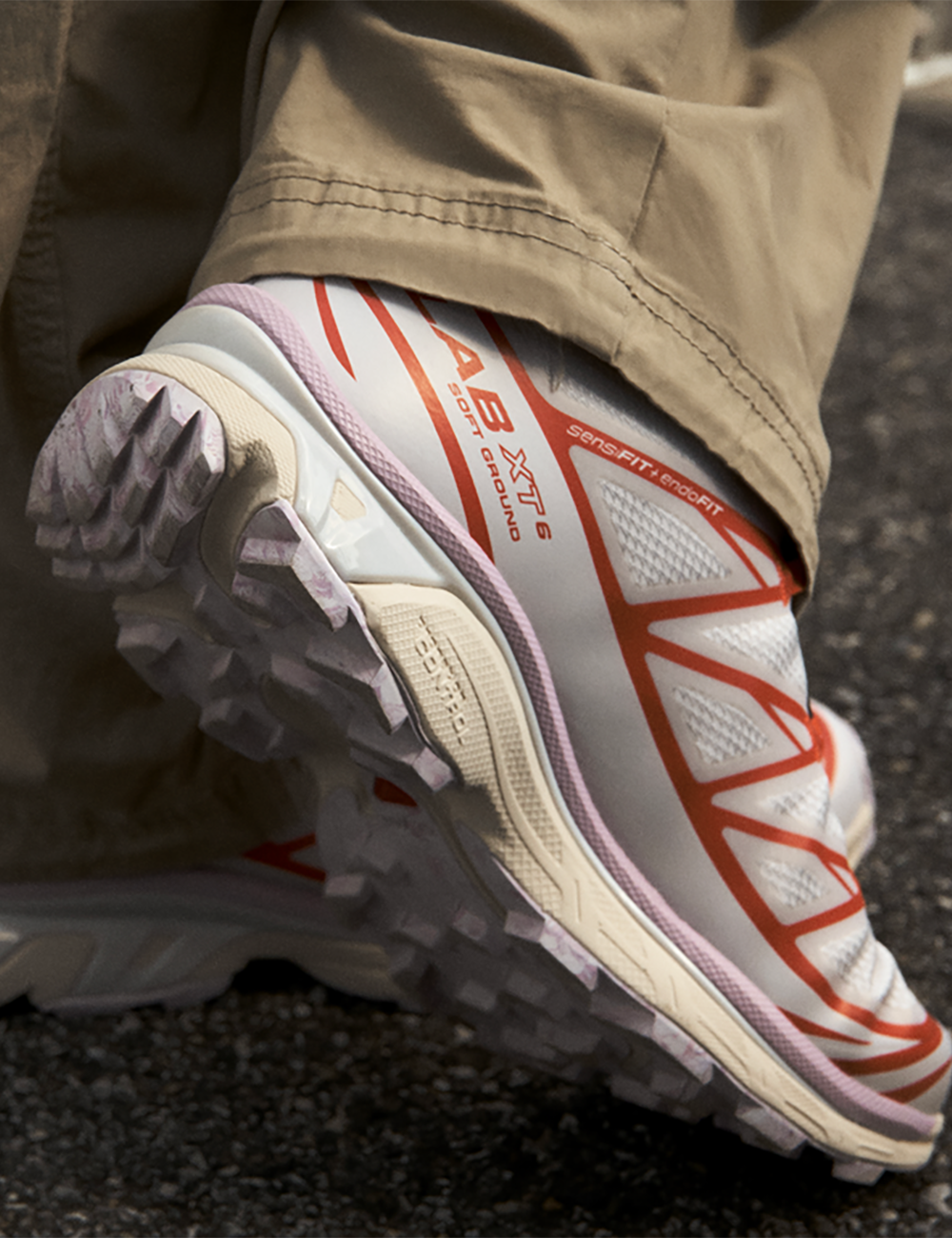 Salomon women XT-6 Nostalgia white and pink sneakers with red details worn on model