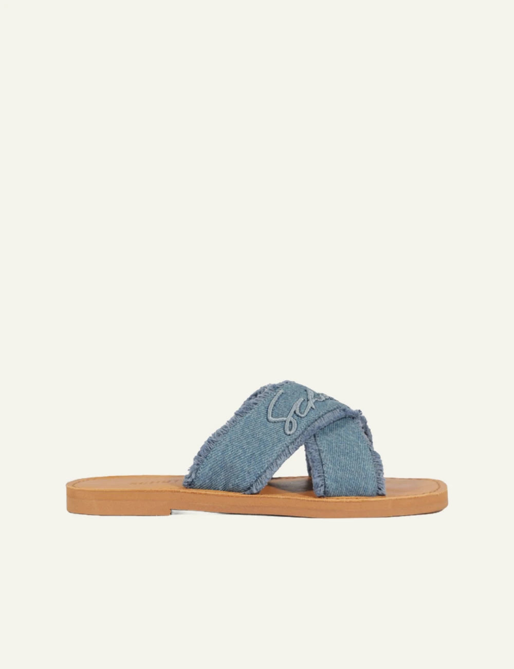 Schutz denim flat sandal with frayed X straps and logo detail side view