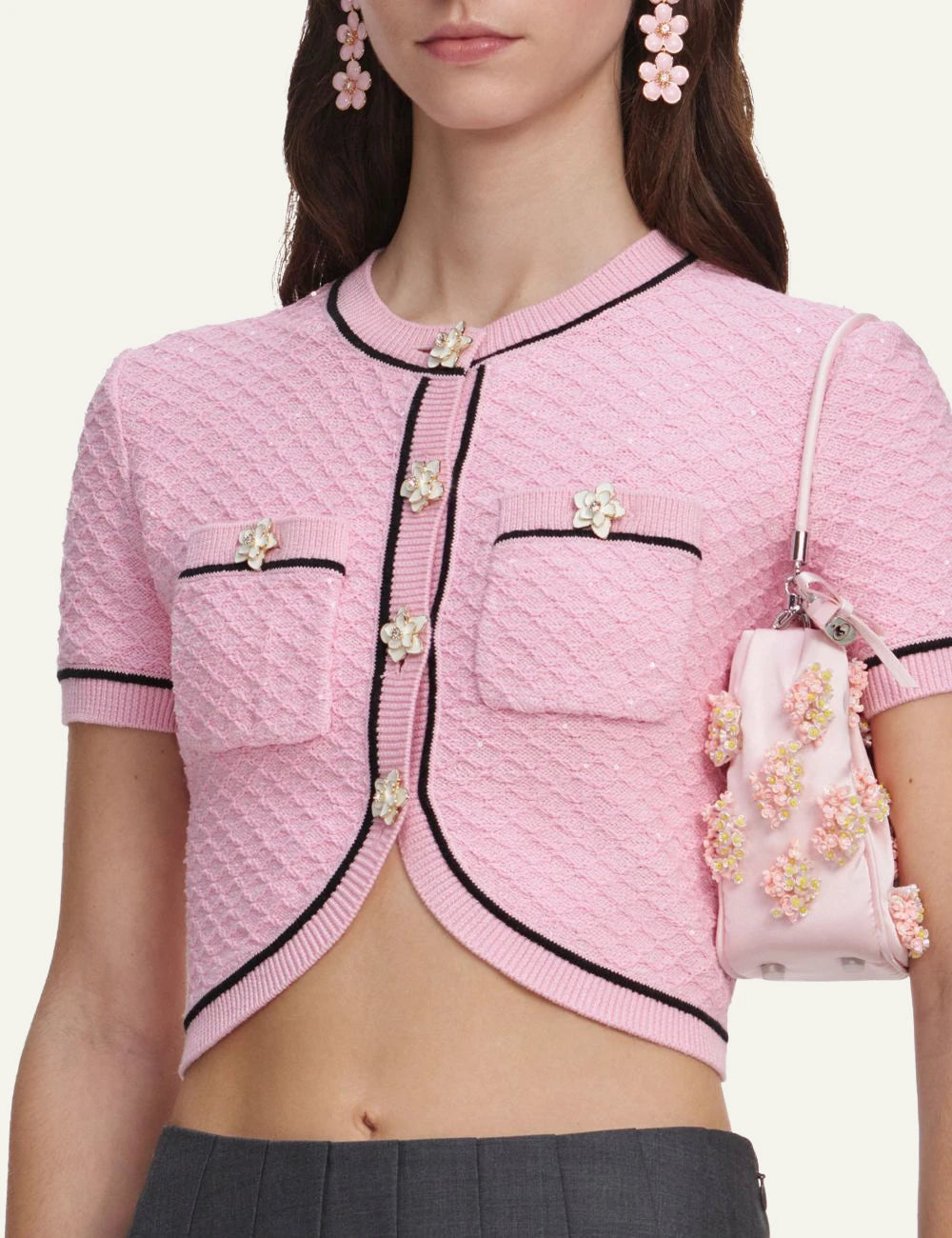Pink cropped knit top with floral buttons and contrast trim by Self-Portrait detail
