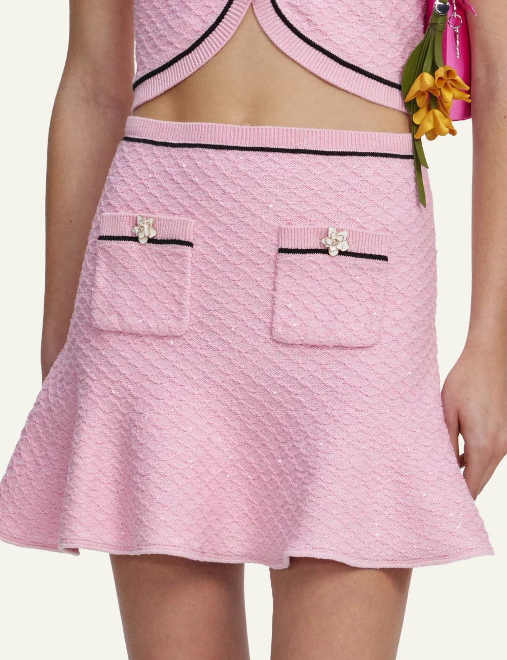 Pink textured mini skirt with contrast trim, floral buttons and flared hem by Self-Portrait detail
