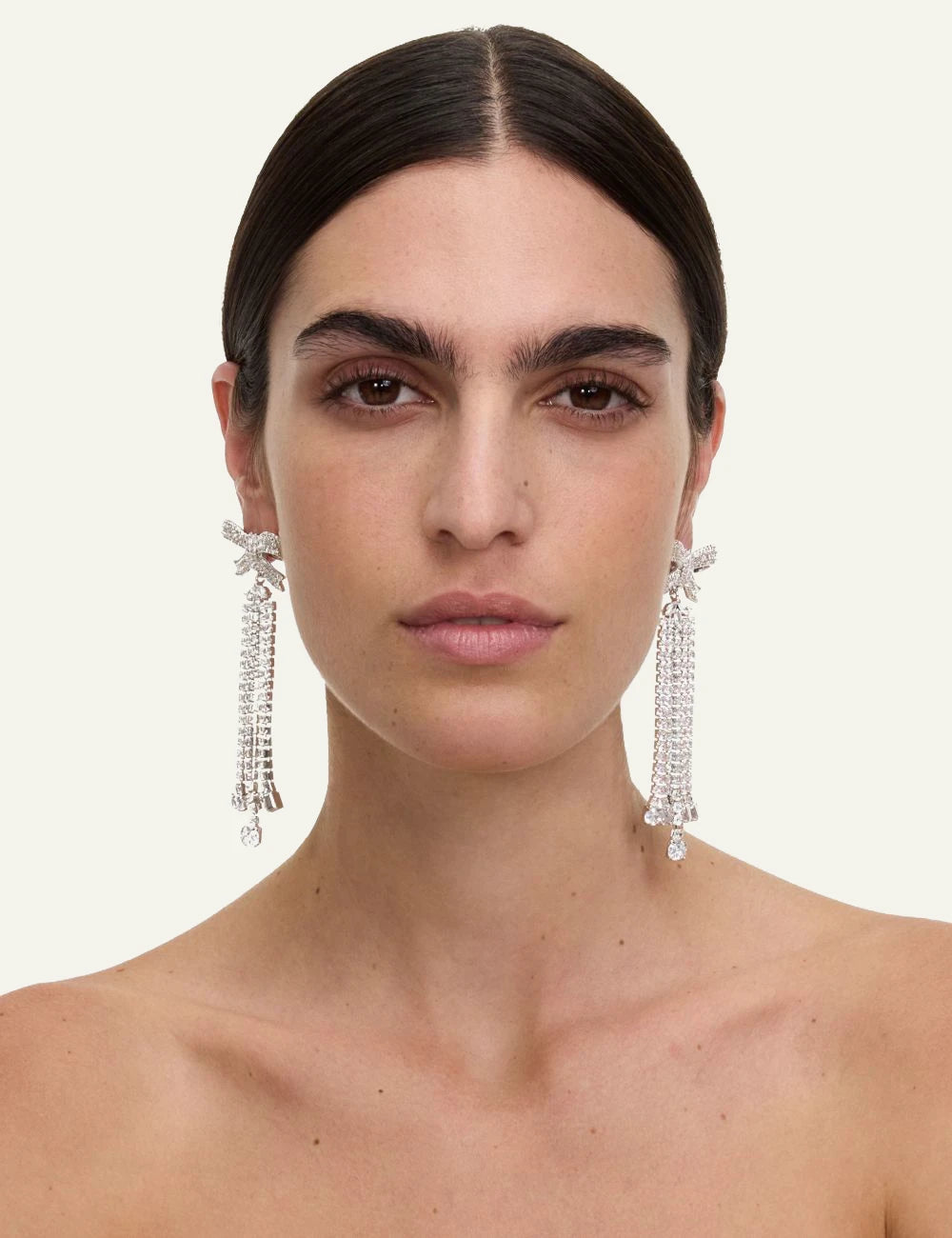 Self-Portrait silver crystal bow earrings worn by model