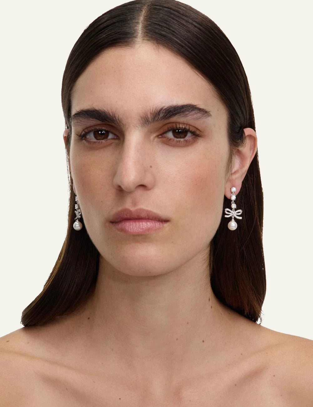 Self-Portrait silver crystal bow pearl drop earrings on model