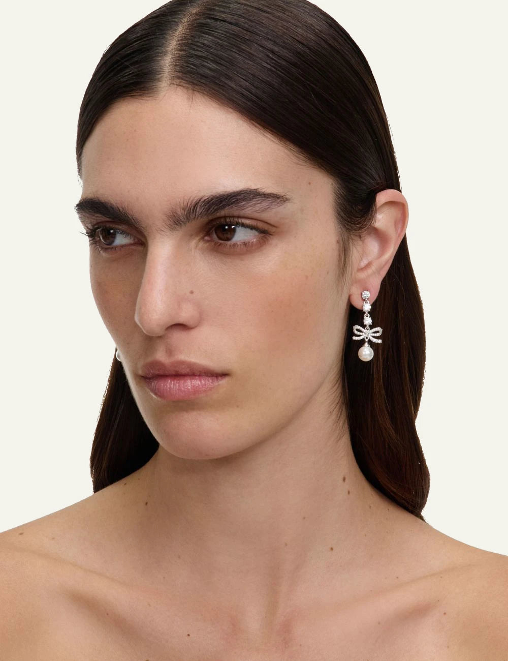 Self-Portrait silver crystal bow pearl drop earrings on model side view