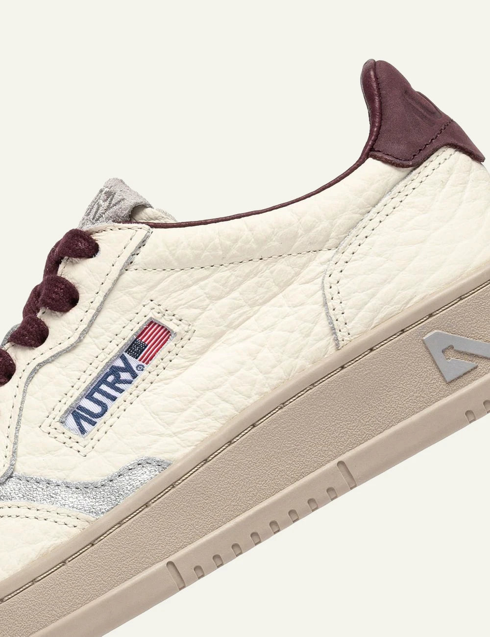 Autry women’s ivory grained leather sneakers with burgundy and silver details logo