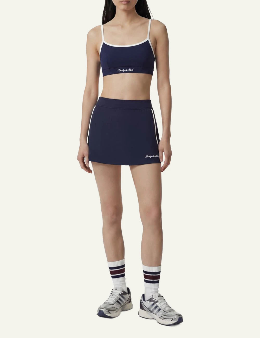 Sporty and Rich sports bra navy with white straps front model view