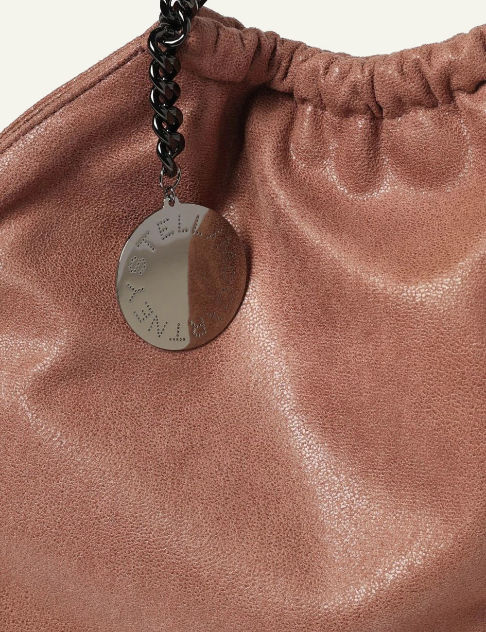 Stella McCartney Falabella clutch bag in dusty pink vegan leather with chain shoulder strap and logo charm, detail view