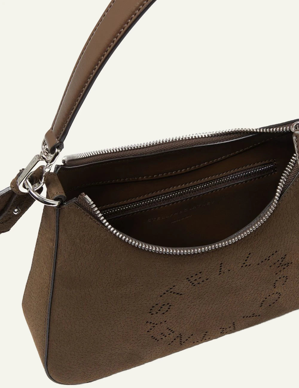 Stella McCartney Logo shoulder bag in brown vegan leather with perforated circular logo and wide strap, logo view