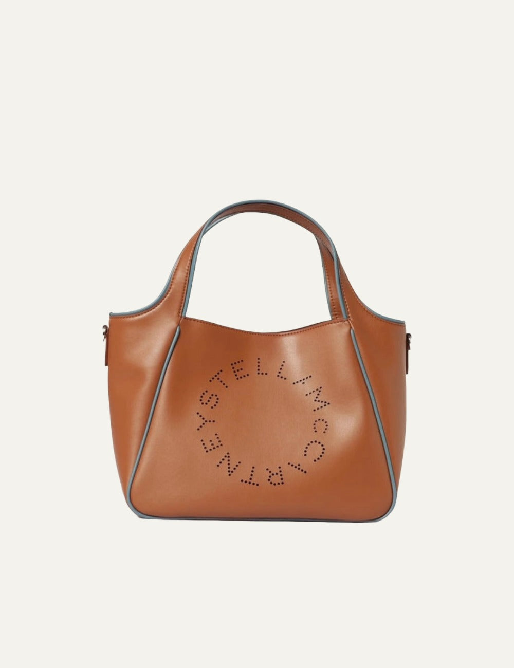 Stella McCartney Logo tote bag in tan vegan leather with perforated circular logo and contrast blue trim, front view