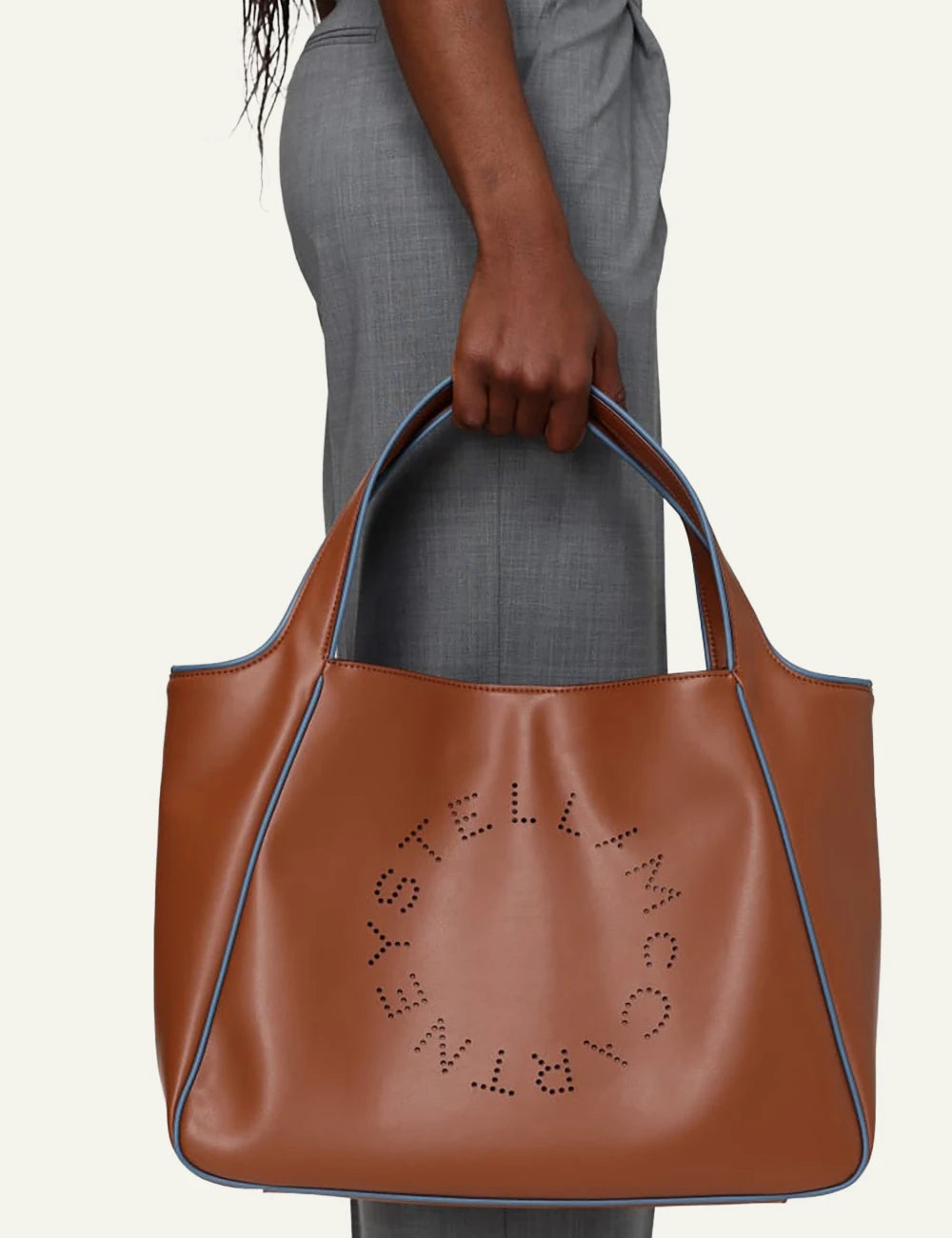 Stella McCartney perforated logo tote bag brown front model view