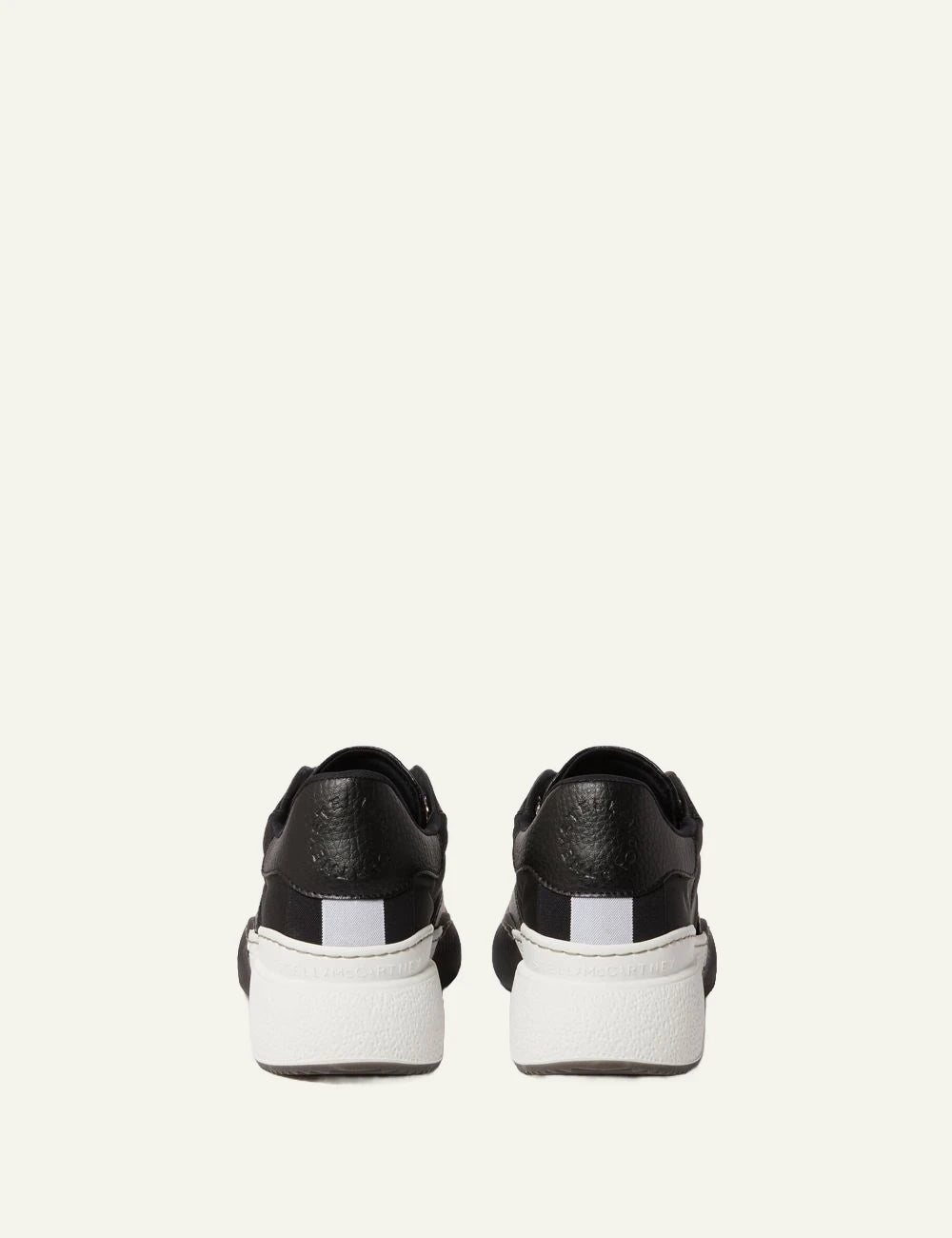 Stella McCartney platform sneaker in black with white laces and chunky white sole, back view