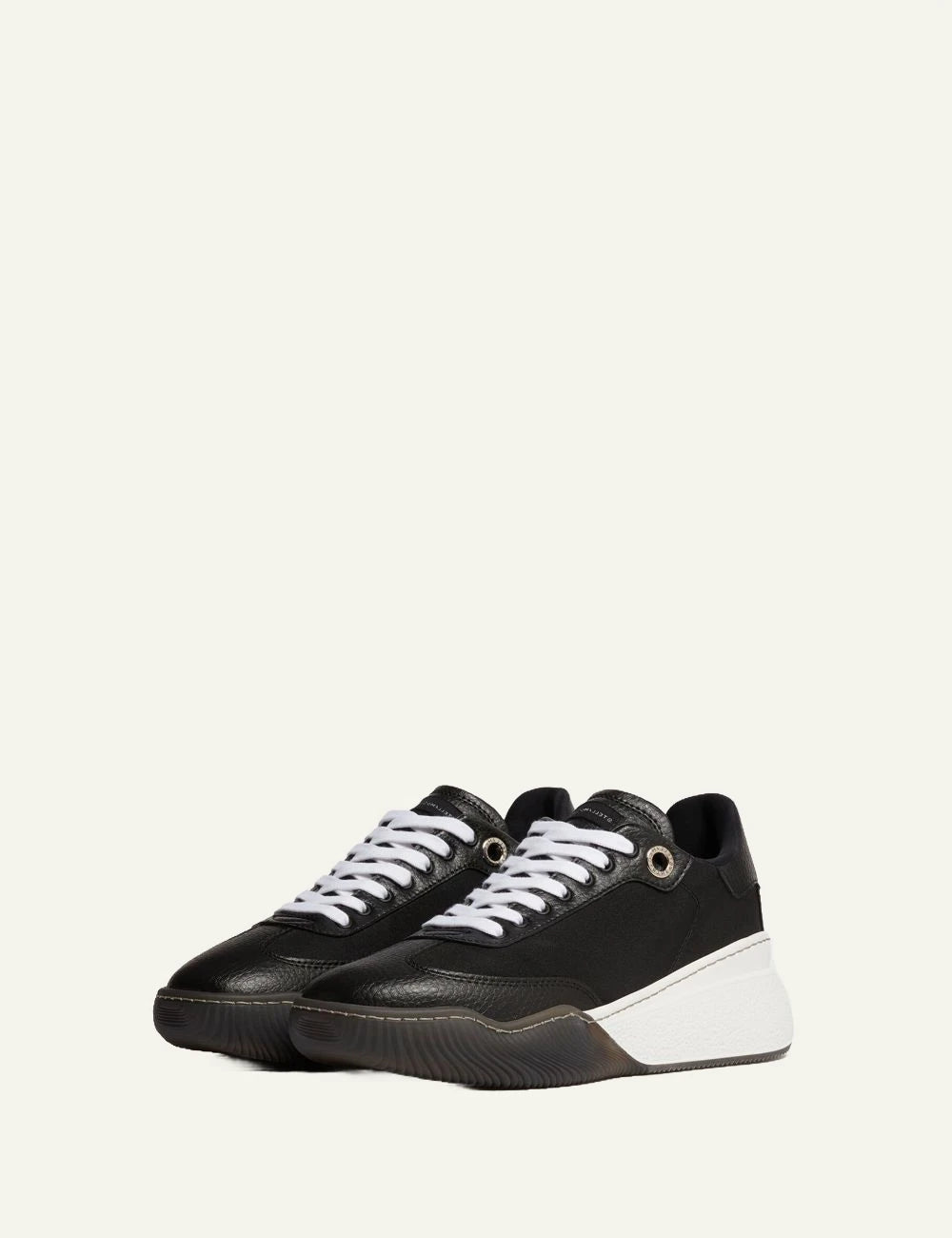 Stella McCartney platform sneaker in black with white laces and chunky white sole, profil view