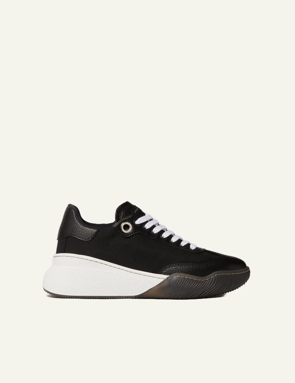 Stella McCartney platform sneaker in black with white laces and chunky white sole, side view