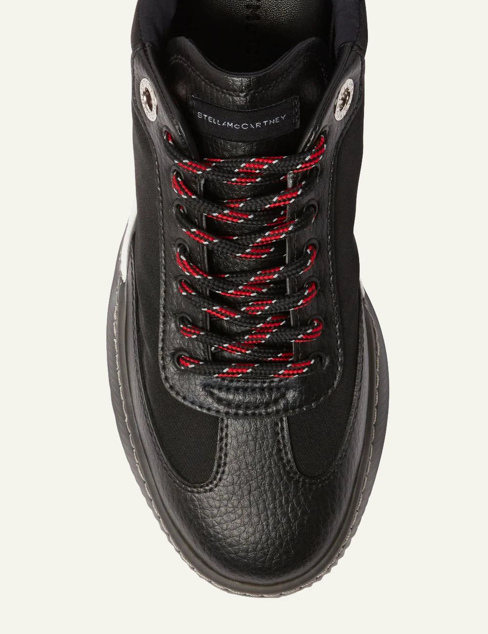 Stella McCartney platform sneaker in black with white laces and chunky white sole, top detail view