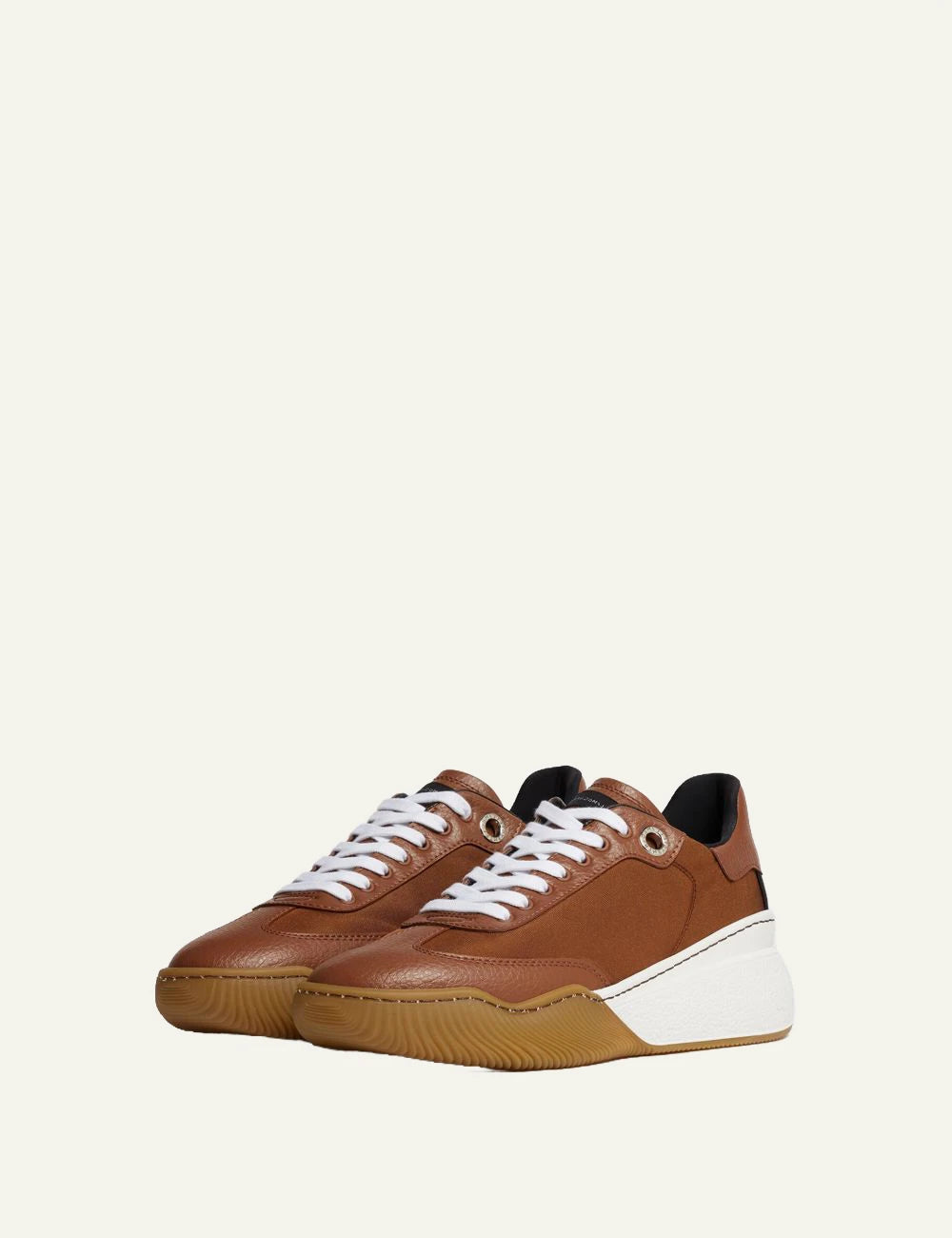 Stella McCartney platform sneaker in brown with white laces and chunky white sole, profil view