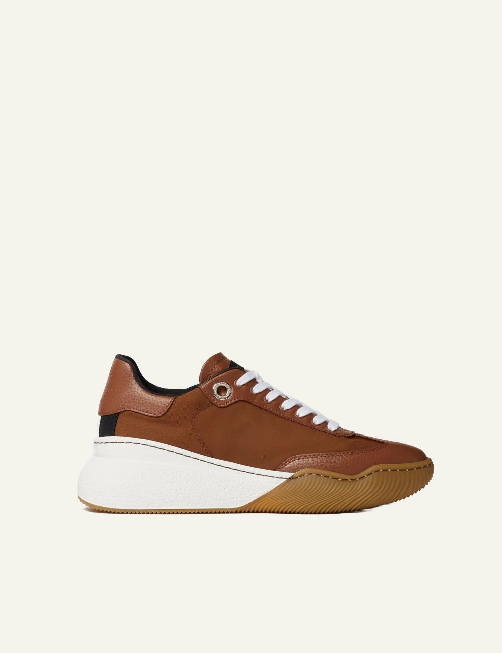 Stella McCartney platform sneaker in brown with white laces and chunky white sole, side view