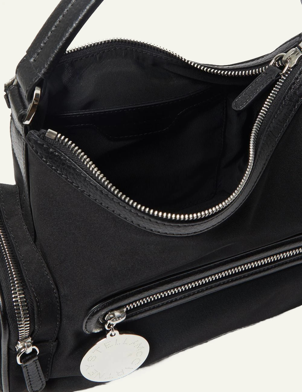 Stella McCartney shoulder bag in black vegan leather with front zip pocket, side compartments and logo coin charm,top view