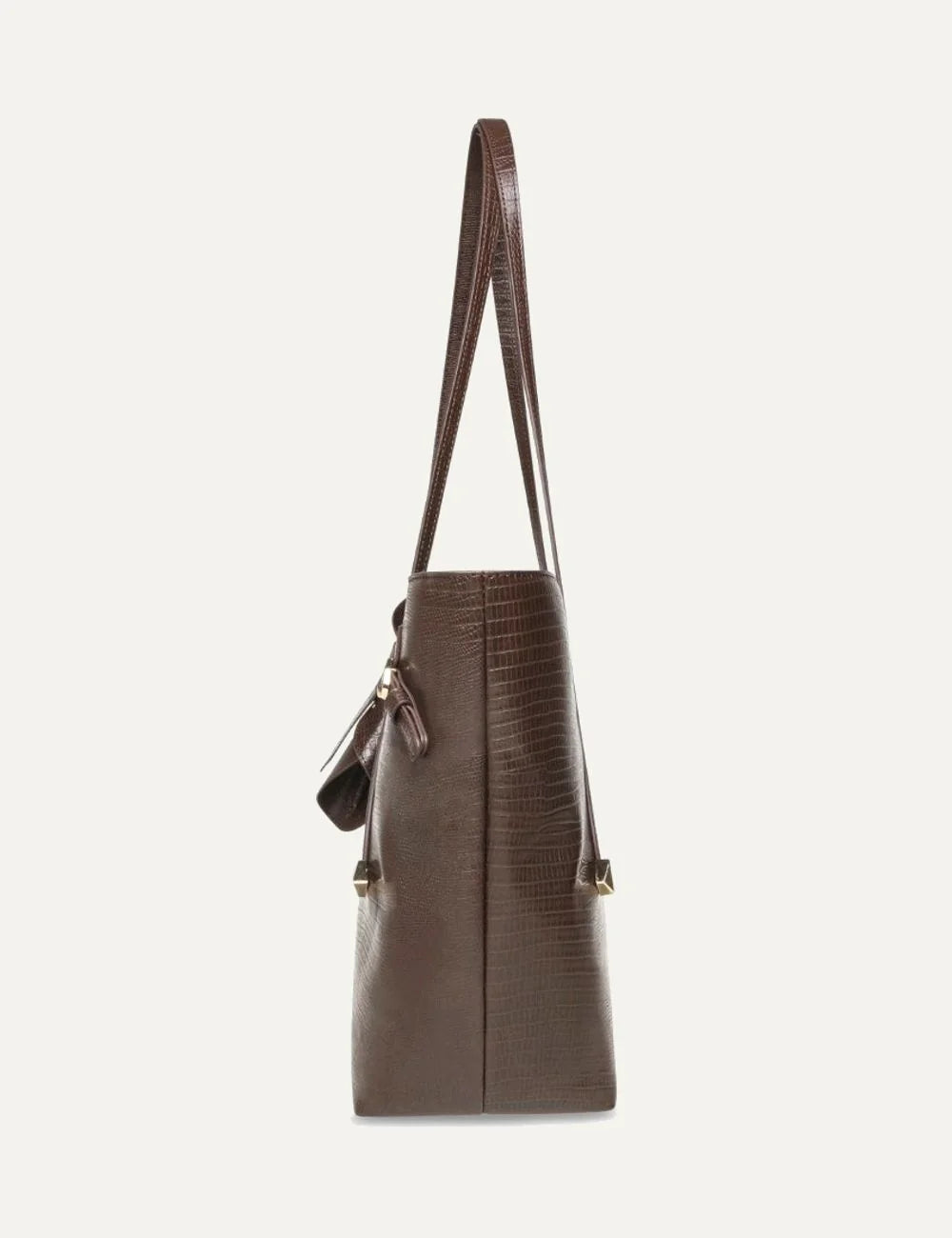 Steve Madden Bdelphin women's chocolate brown tote shoulder bag with embossed lizard effect texture, two long handles, decorative buckle straps, gold tone hardware and small front logo,  side view