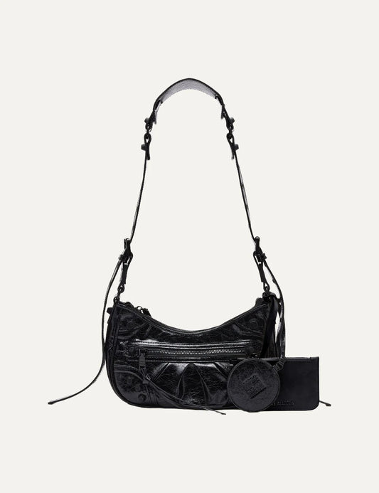 Steve Madden Bglowing women's black glossy textured shoulder bag with curved silhouette, front zipper pocket, long adjustable strap, removable zip pouch and round mirror charm, front view.