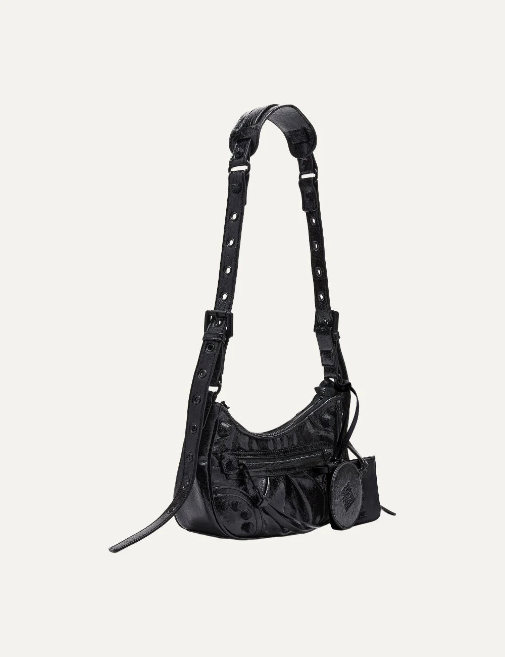 Steve Madden Bglowing women's black glossy textured shoulder bag with curved silhouette, front zipper pocket, long adjustable strap, removable zip pouch and round mirror charm, side view