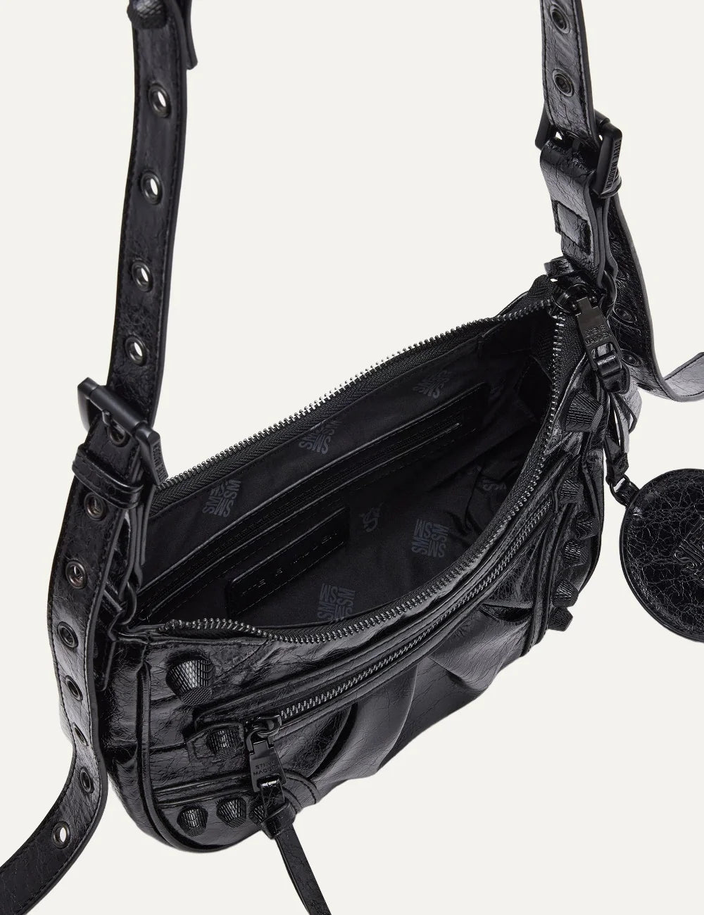  Steve Madden Bglowing women's black glossy textured shoulder bag with curved silhouette, front zipper pocket, long adjustable strap, removable zip pouch and round mirror charm, interior view