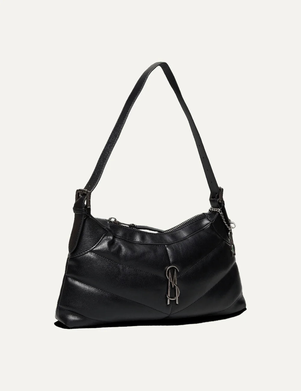 Steve Madden women's black faux leather shoulder bag with chevron quilted stitching, elongated curved silhouette, slim shoulder strap, gunmetal tone SM logo, side chain charm and top zipper, side view