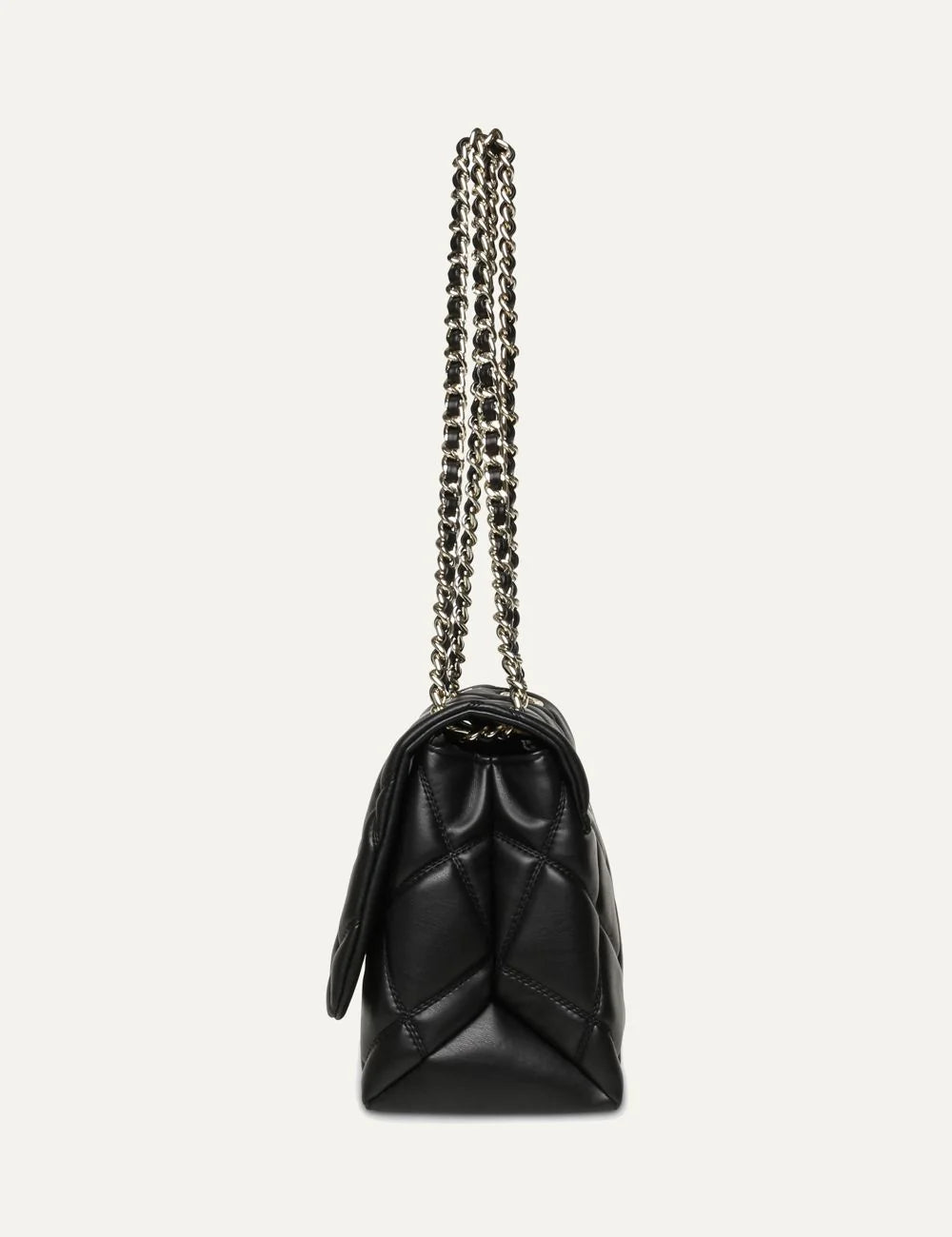 Steve Madden women's black quilted shoulder bag with diamond stitching, gold tone SM logo on front flap, magnetic closure and gold chain strap with woven black detailing,  side view
