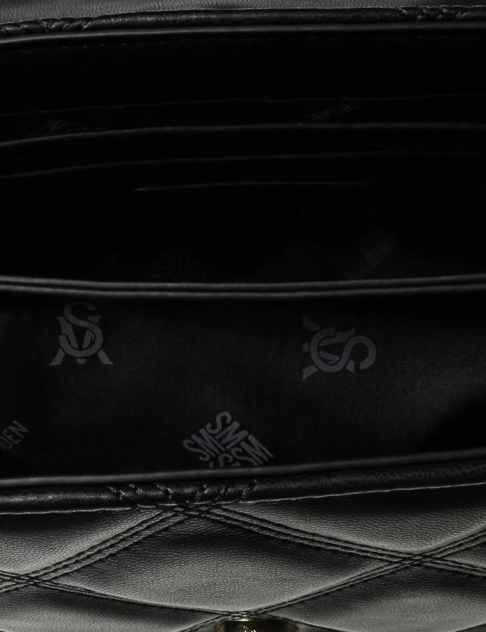 Steve Madden women's black quilted shoulder bag with diamond stitching, gold tone SM logo on front flap, magnetic closure and gold chain strap with woven black detailing,  interior view