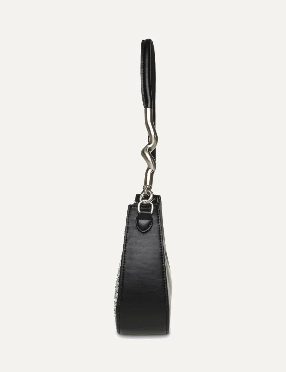 Steve Madden women's black and silver shoulder bag with reflective triangular embellishments, curved silhouette, silver tone SM logo, slim strap with sculptural metal detail and top zipper, side view