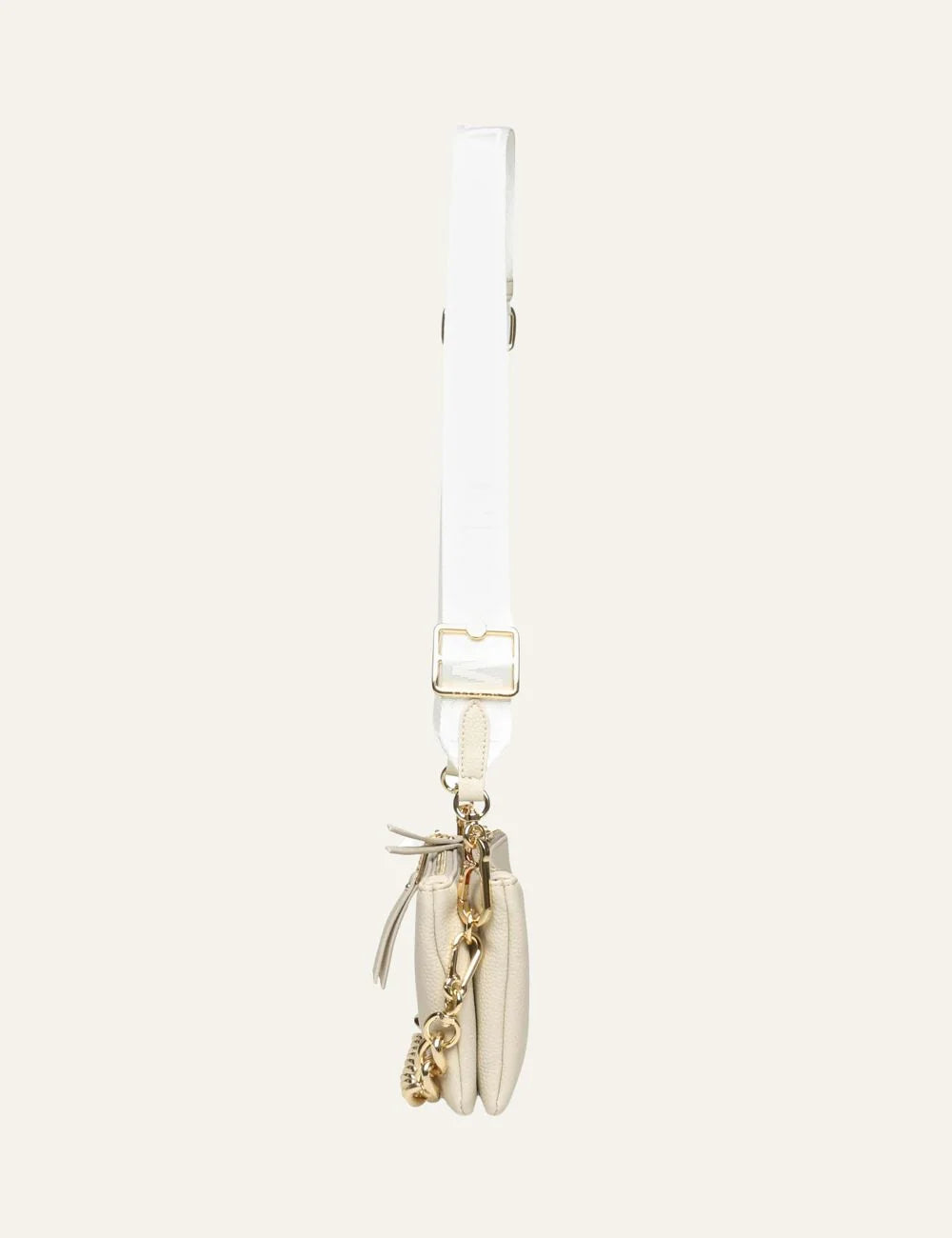 Steve Madden Bnicco women's ecru synthetic leather crossbody bag with embossed front logo, adjustable branded shoulder strap, gold tone chain detail along the bottom and top zip closure, side view