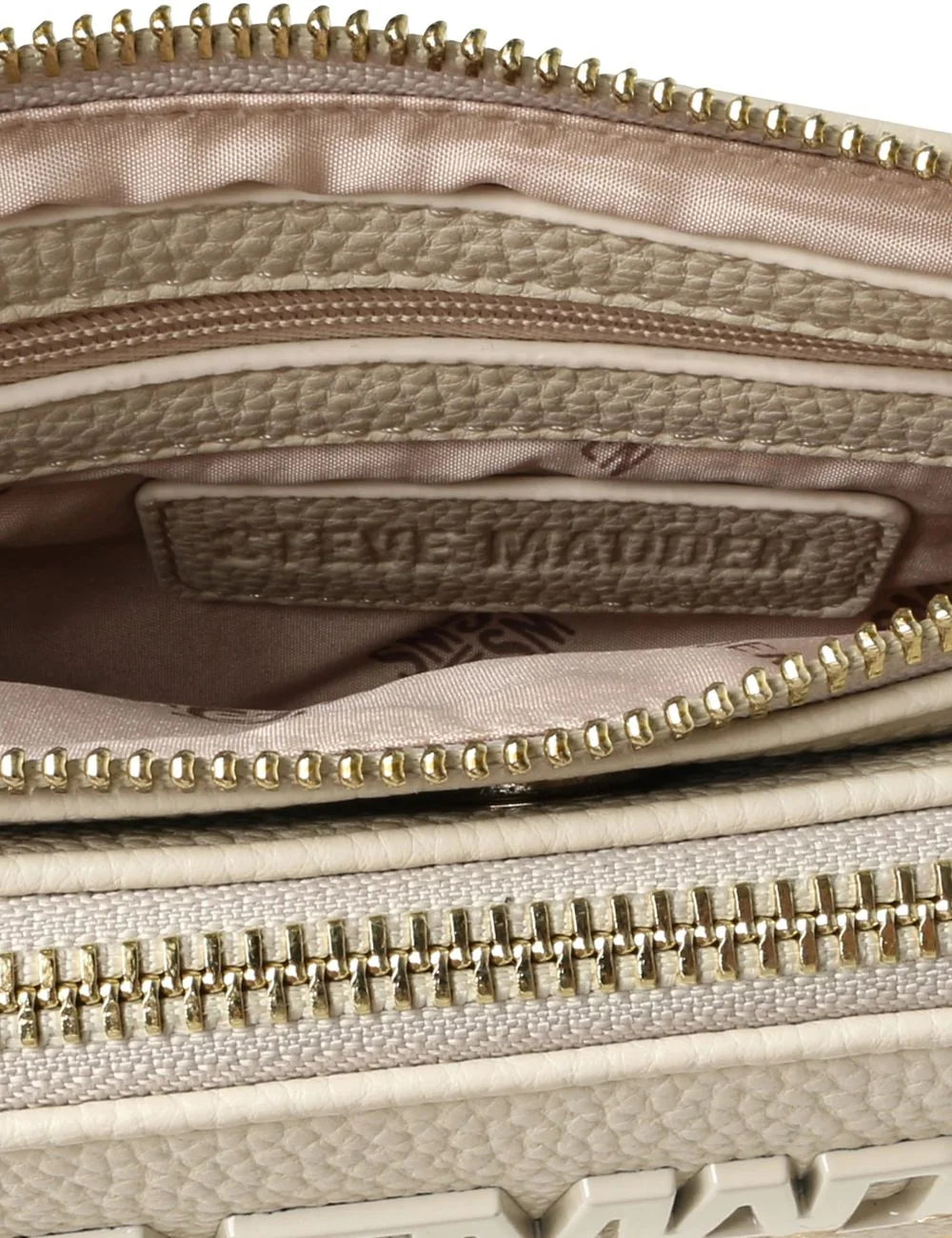 Steve Madden Bnicco women's ecru synthetic leather crossbody bag with embossed front logo, adjustable branded shoulder strap, gold tone chain detail along the bottom and top zip closure,  interior view
