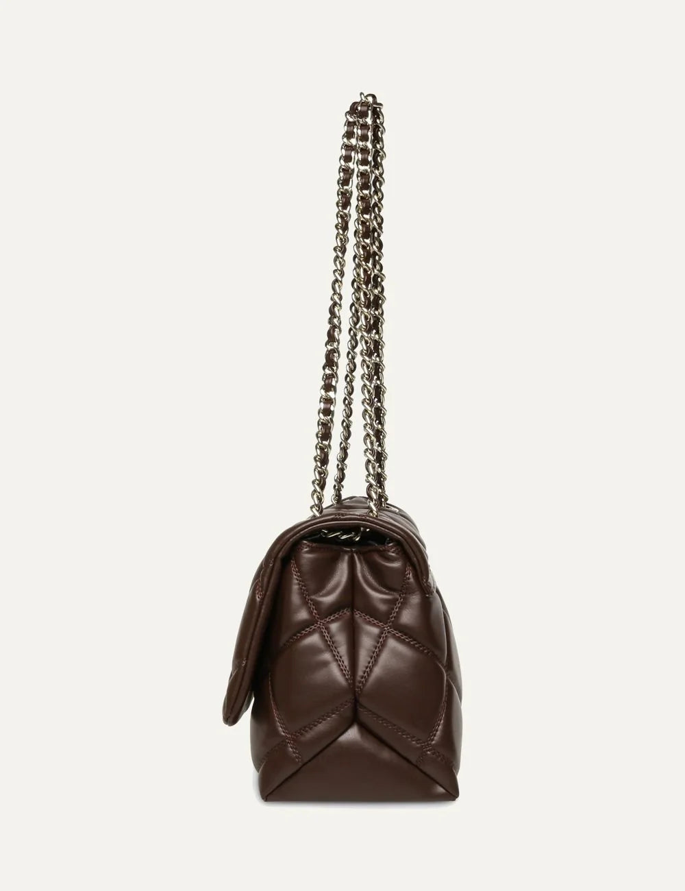 Steve Madden women's chocolate brown quilted shoulder bag with diamond stitching, gold tone SM logo on front flap, magnetic closure and gold chain strap with woven brown detailing,  side view