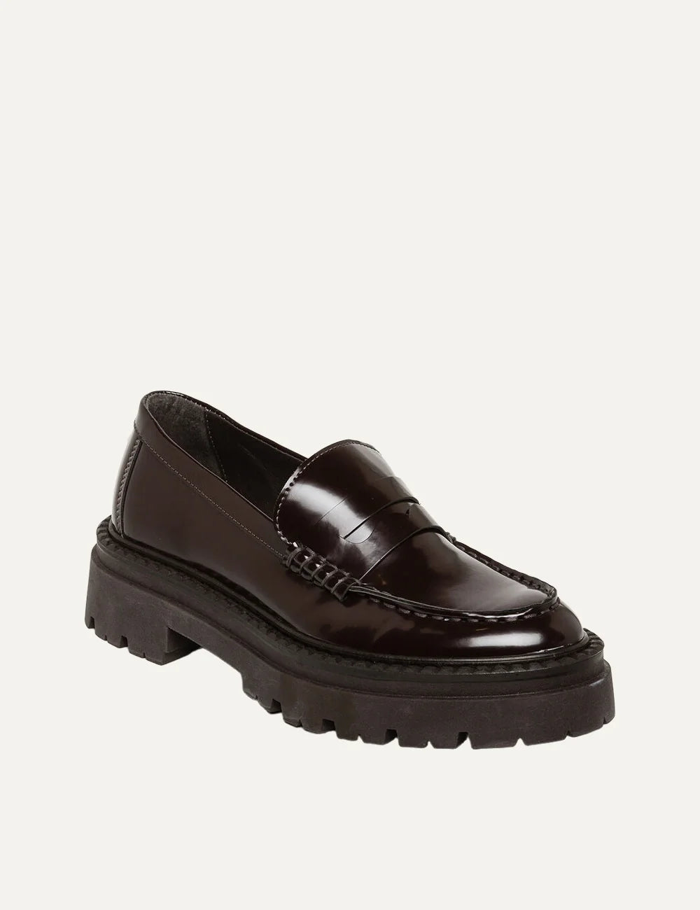 Steve Madden Katja women's dark brown glossy synthetic penny loafers featuring a classic vamp strap, moc toe stitching, slip-on design and chunky dark brown lug sole,  front angle view