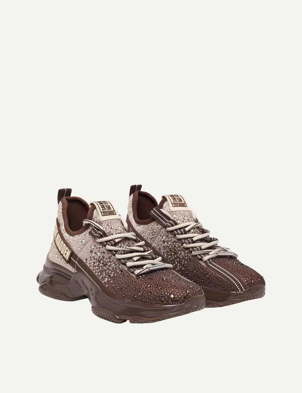 Steve Madden Mistica women's chunky sneakers in brown and taupe, embellished with sparkling rhinestones, featuring a gradient textile upper, beige and brown laces, oversized Steve Madden side logo and glossy brown sculpted sole,  pair front angle view