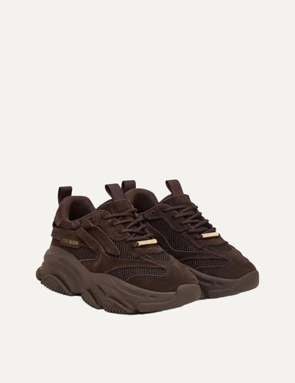 Steve Madden Possession-E women's chunky sneakers in chocolate brown, featuring suede-effect overlays, mesh panels, lace-up fastening, gold-tone side logo and oversized sculpted sole, front angle view