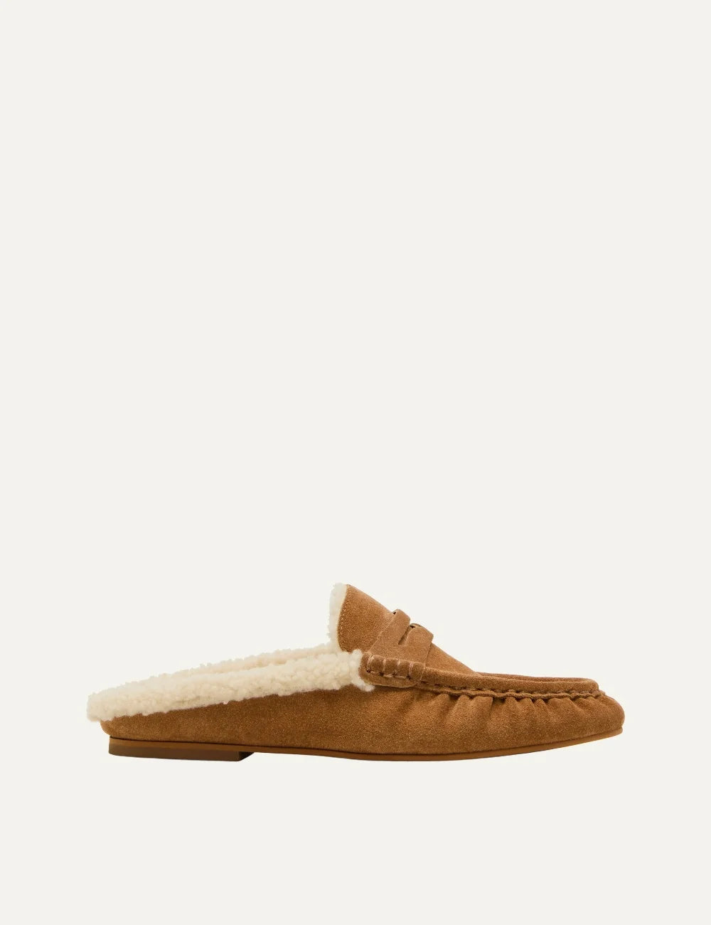 Steve Madden Rafe-F women's camel suede mule loafers with cream faux fur lining, open back, penny strap detail, gathered moccasin toe stitching and flat sole, side view.