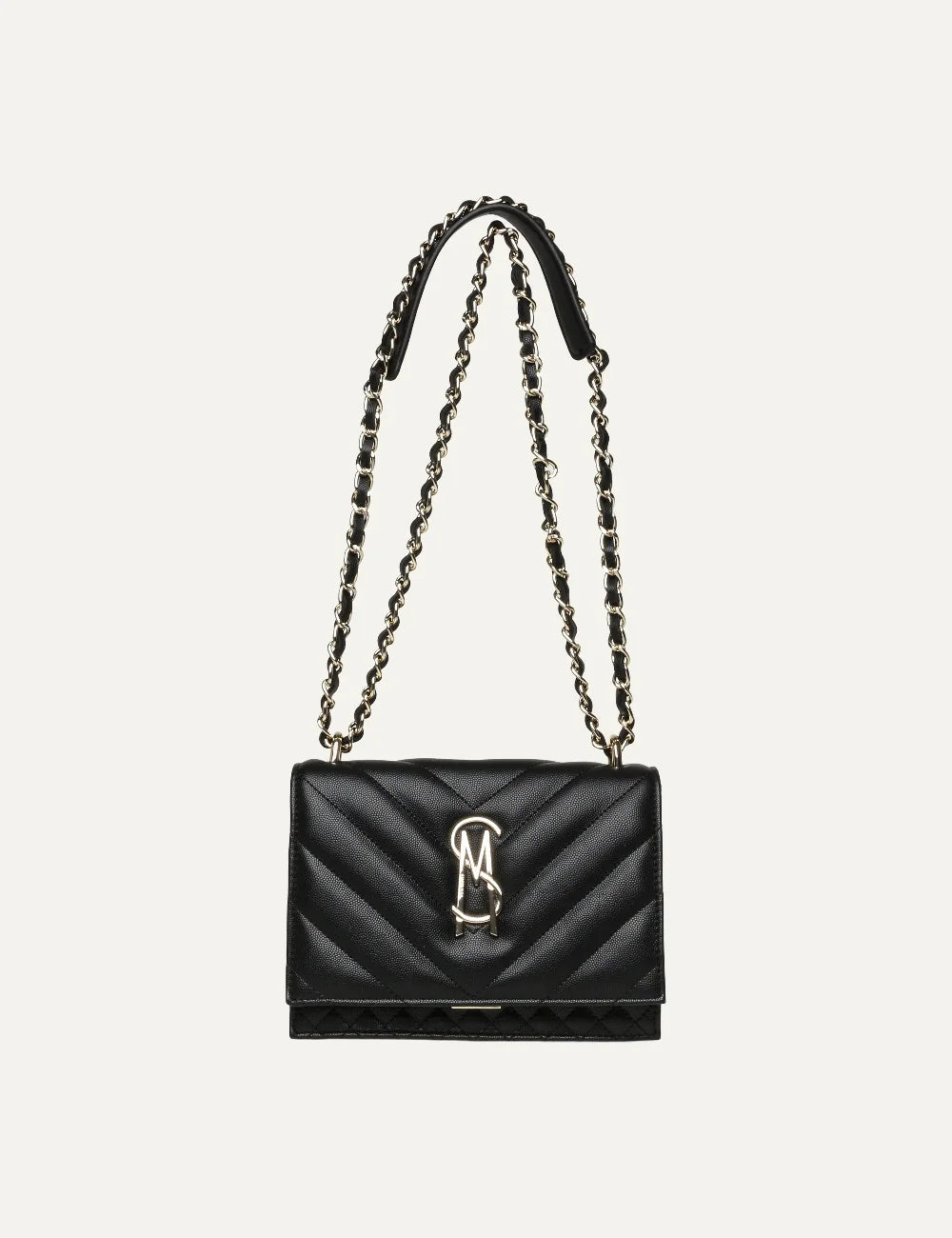 Steve Madden women's black quilted flap shoulder bag with chevron stitching, gold tone metal logo and double gold chain strap interwoven with black material, front view.