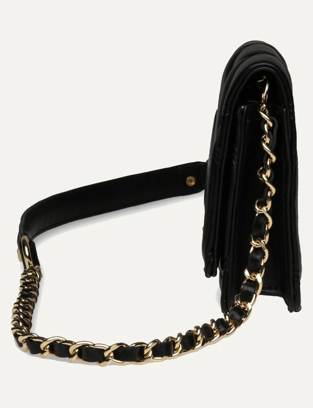 Steve Madden women's black quilted crossbody bag with diamond stitching, gold tone SM logo on front flap, and gold chain strap with woven black detailing, side view