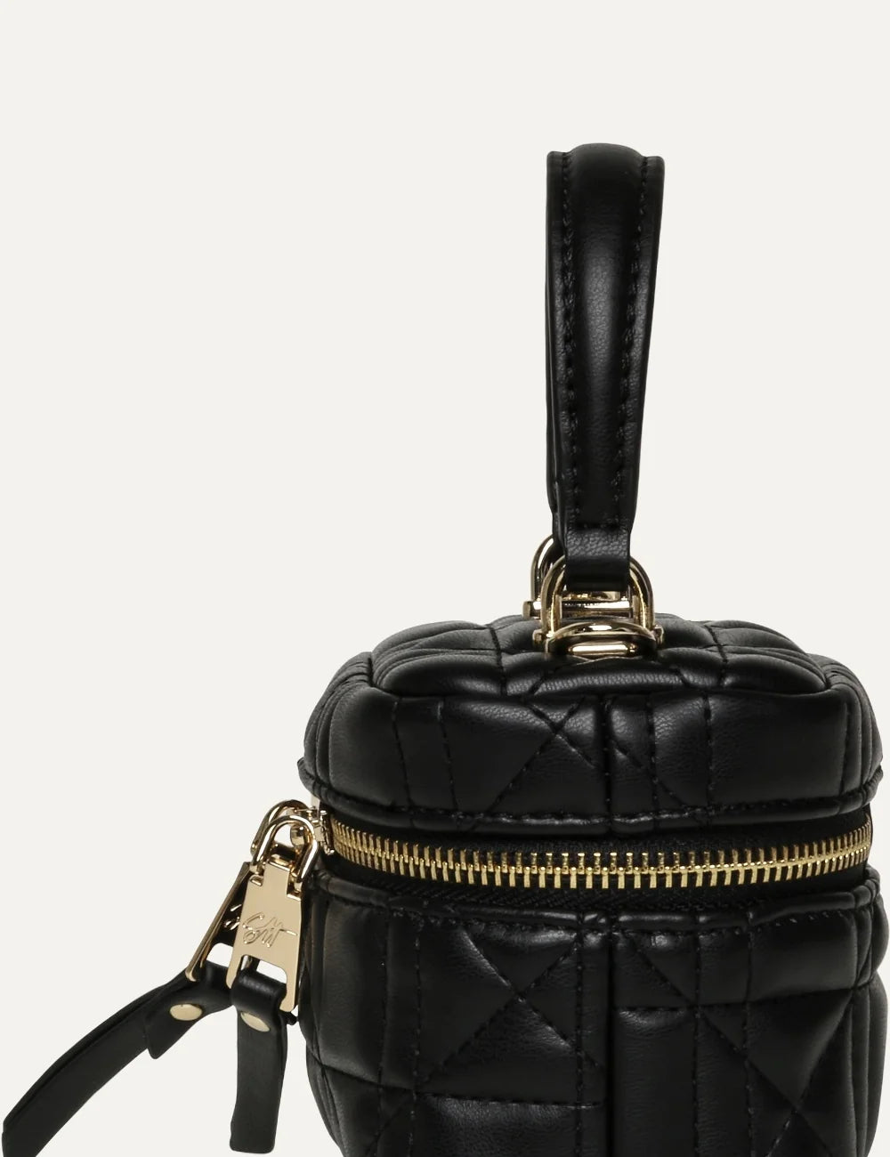 Steve Madden women's mini black quilted synthetic leather handbag with top handle, gold tone double zip closure, elongated zipper pulls and gold SM logo on the front,  side view