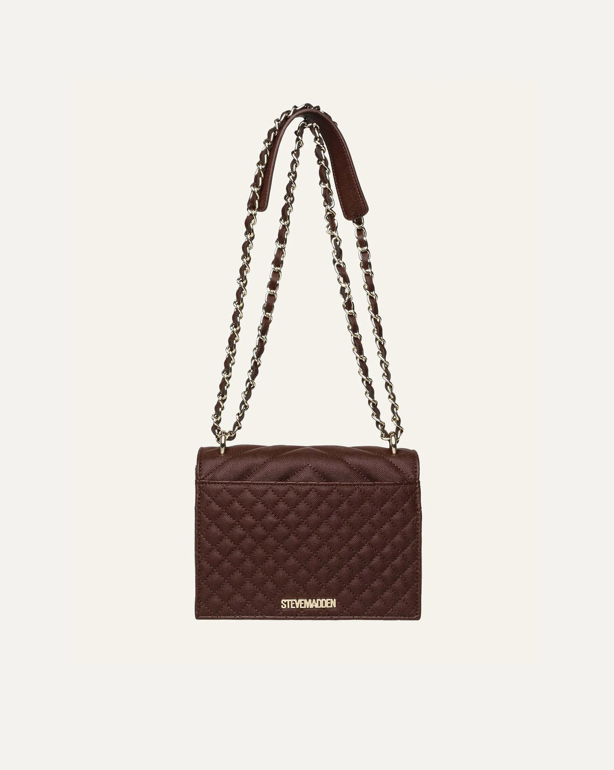 Steve Madden women's chocolate brown quilted shoulder bag with chevron stitched flap, gold tone metal logo and double gold chain strap interwoven with brown synthetic material, side view